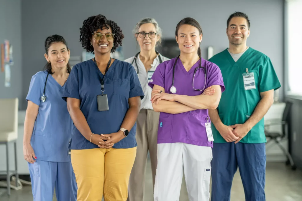 Healthcare professionals standing together, smiling confidently.